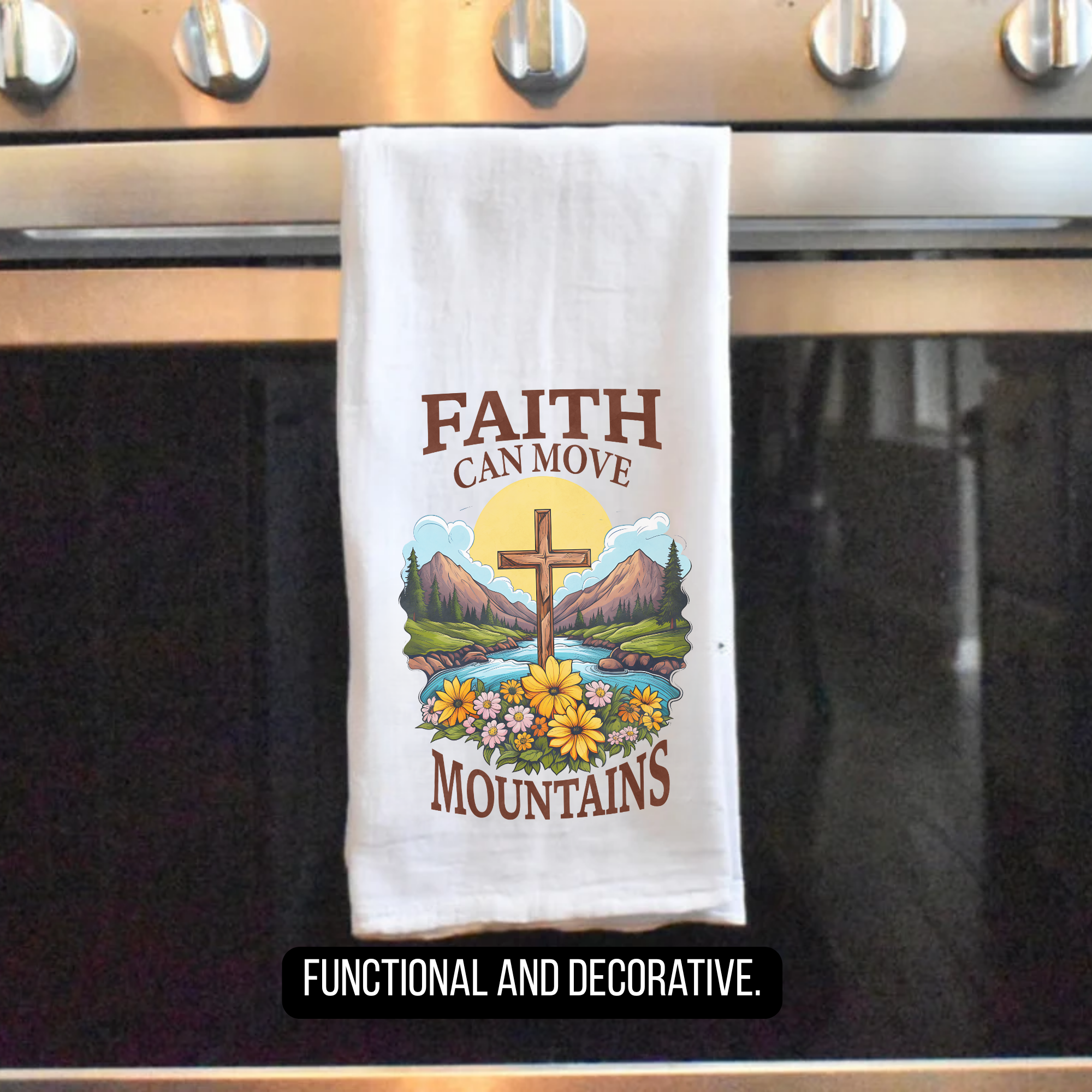 Decorative tea towel with cross and nature design hanging on a stove handle