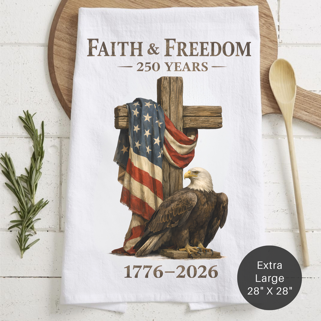 Tea towel with cross, American flag, and bald eagle design on a wooden board.