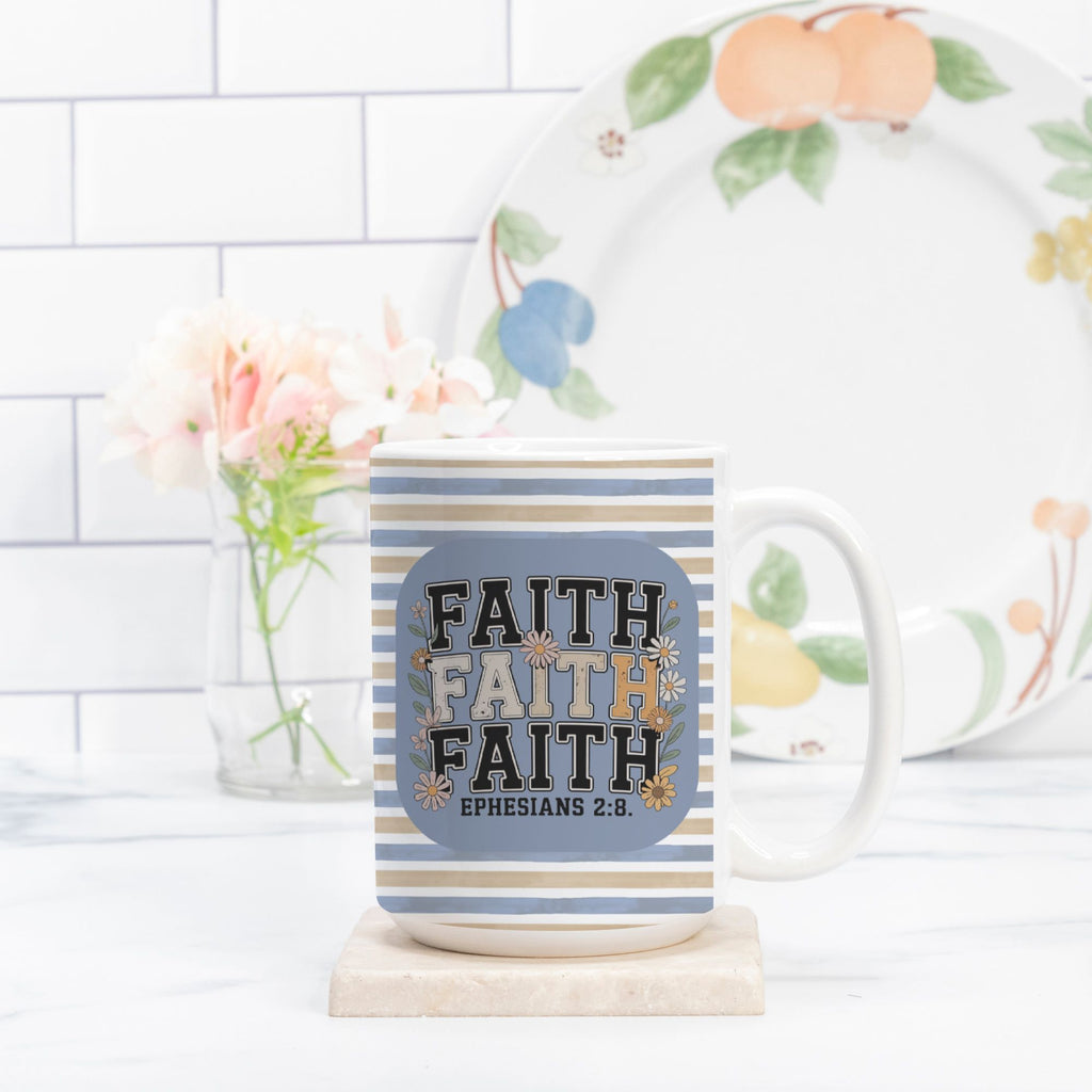 Mug with 'Faith' text and floral plate in the background