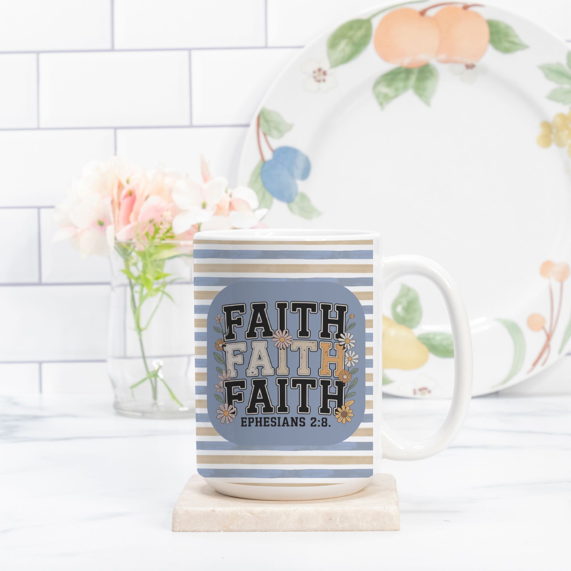 Mug with 'Faith' text and floral plate in the background