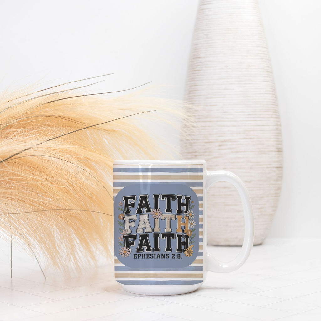 Mug with 'Faith' text and stripes on a white surface with decorative elements