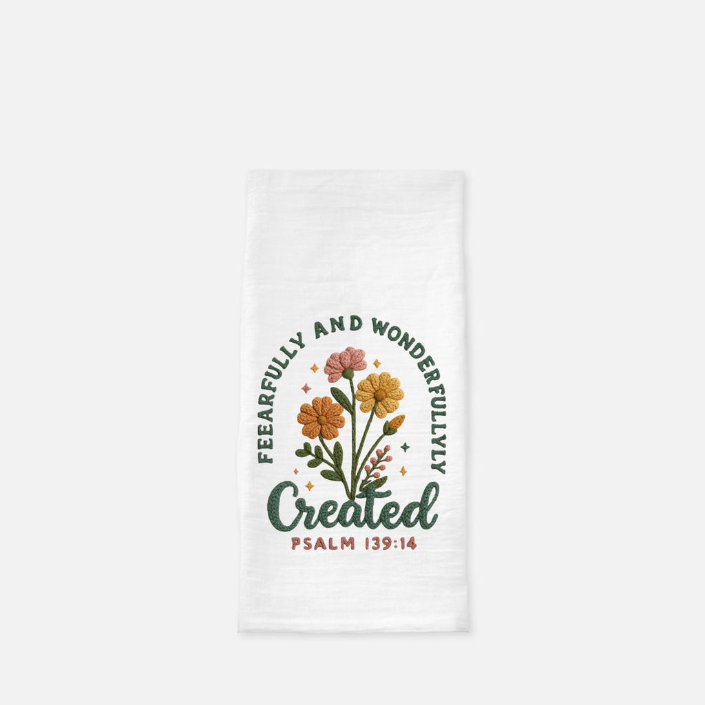 White tea towel with floral design and text 'Fearfully and Wonderfully Created Psalm 139:14' on a white background
