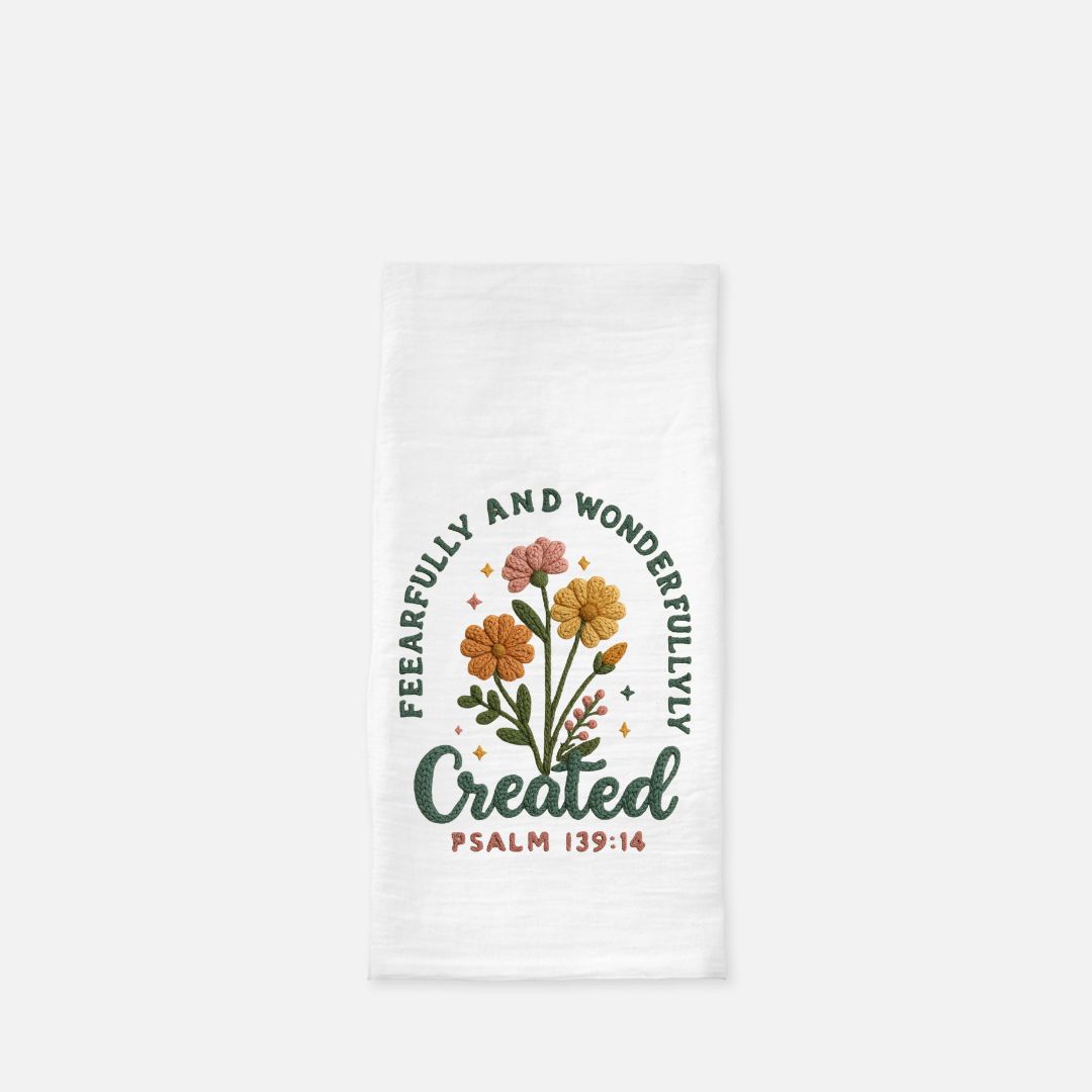 White tea towel with floral design and text 'Fearfully and Wonderfully Created Psalm 139:14' on a white background
