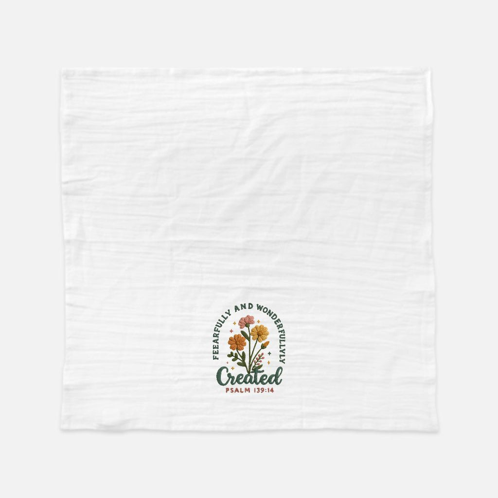 White towel with floral design and text on a white background