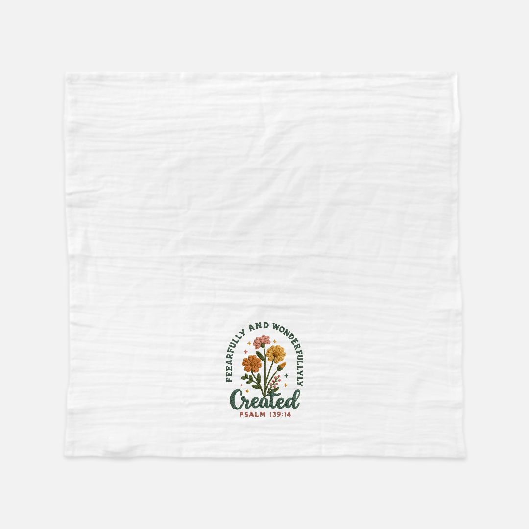 White towel with floral design and text on a white background