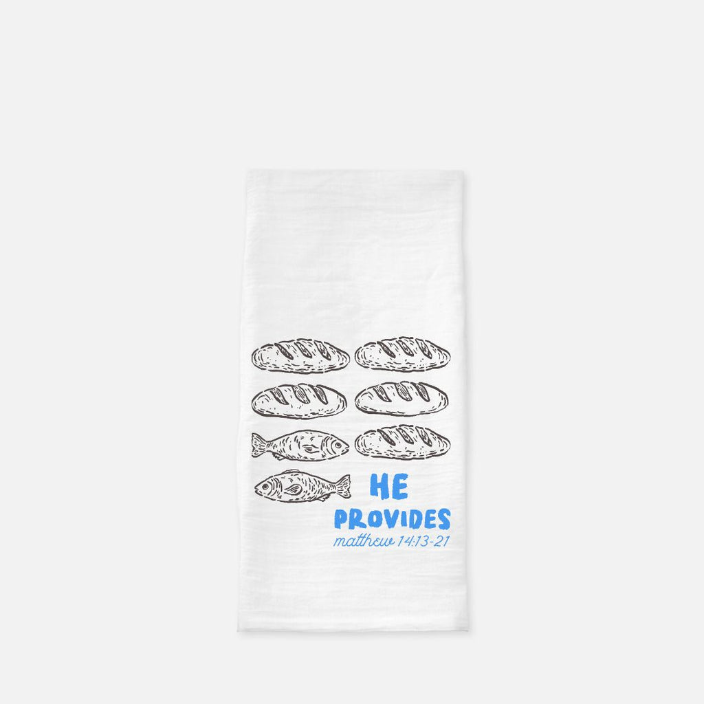 White towel with bread and fish illustrations and 'He Provides' text on a white background