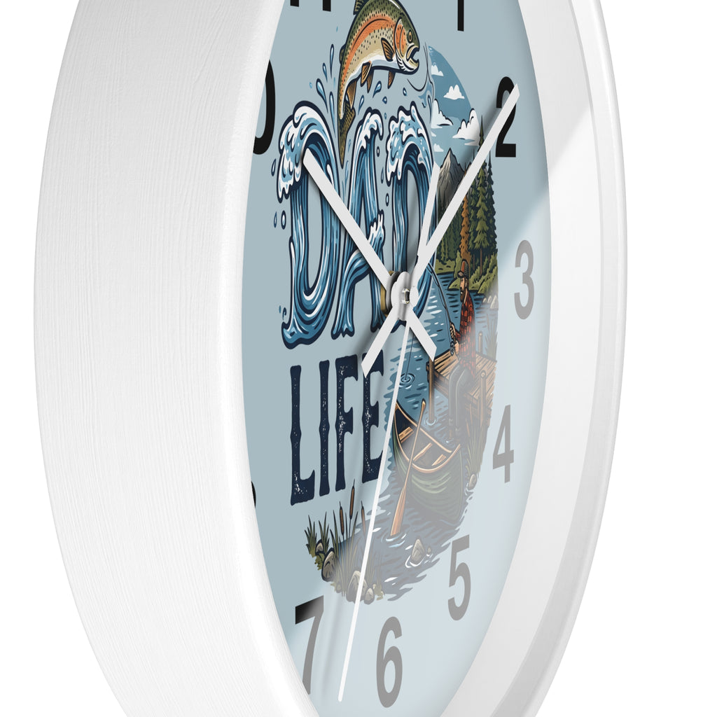 Side view of a round white wall clock with a design of a fish, waves, and the text 'Dad Life' on a light blue background.