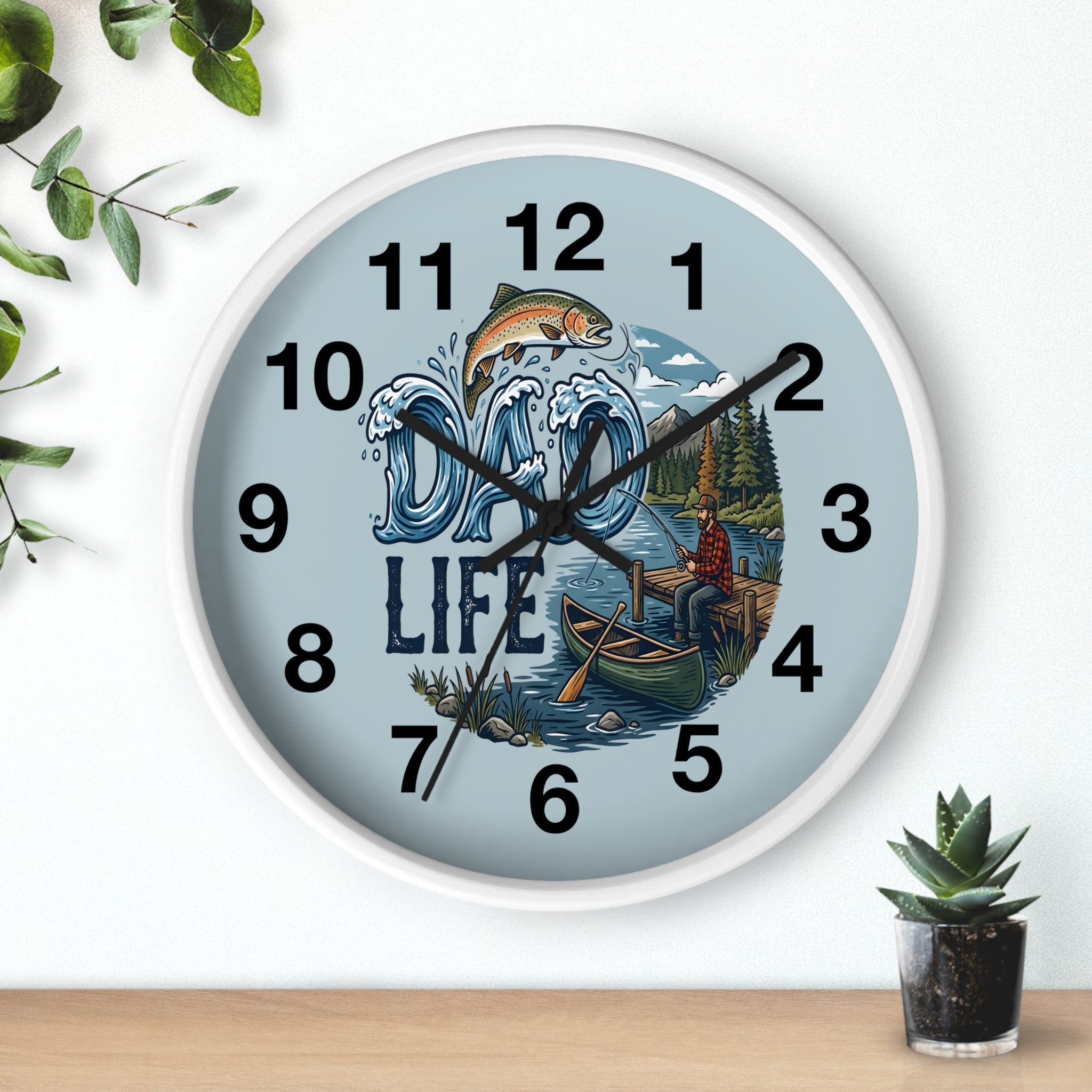 White Wall clock with nature-themed design featuring a fish, mountains,  a lake, and text 'Dad Life' on a light blue background.