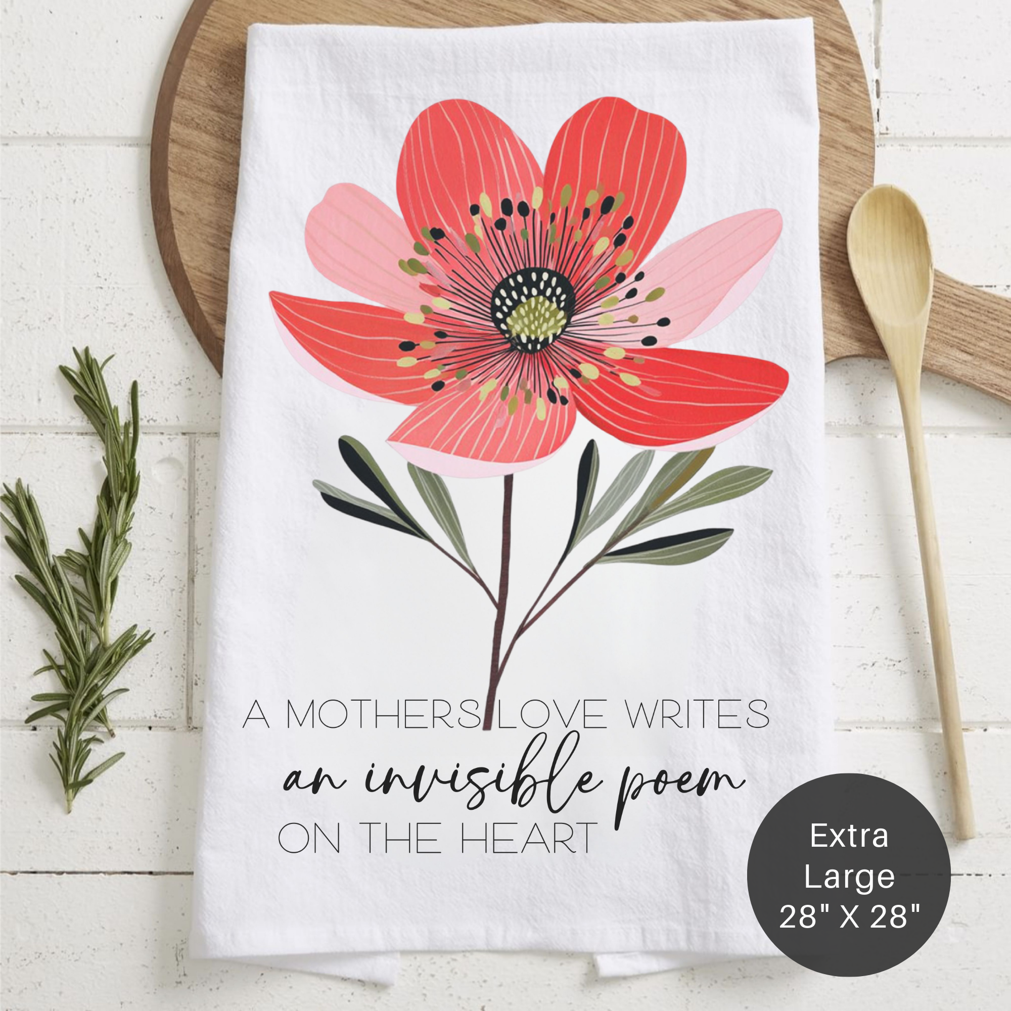 Floral-themed tea towel with a quote on a wooden surface