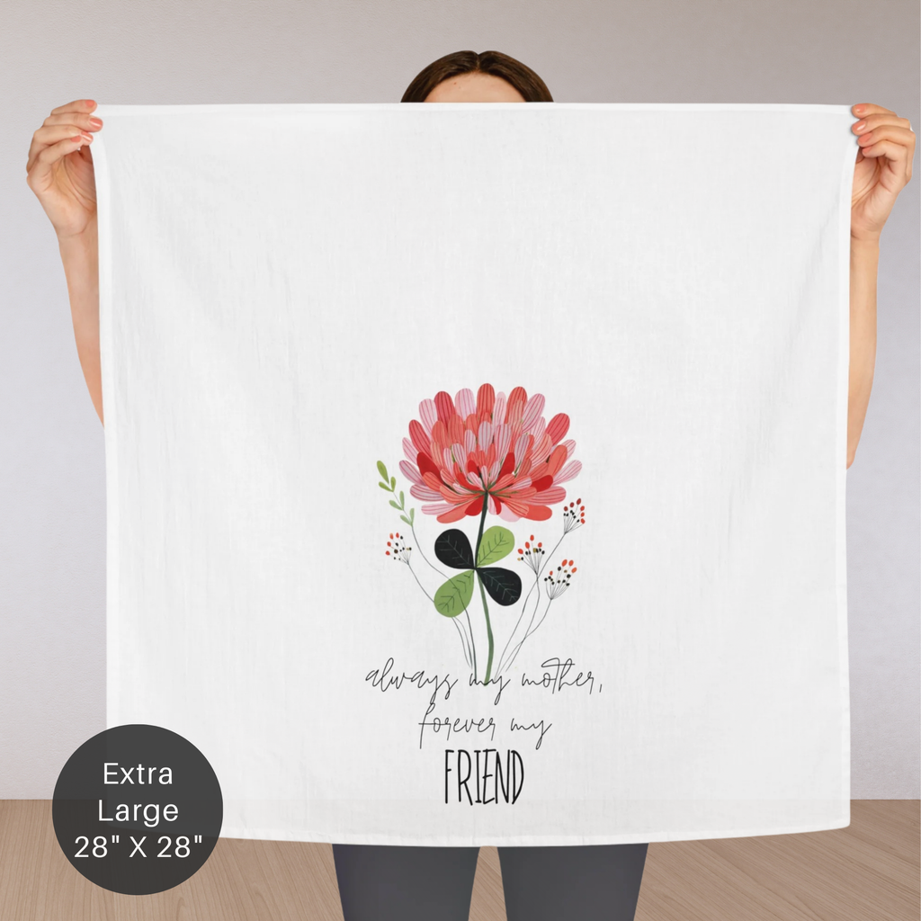 Person holding an extra large white tea towel with floral design and text.
