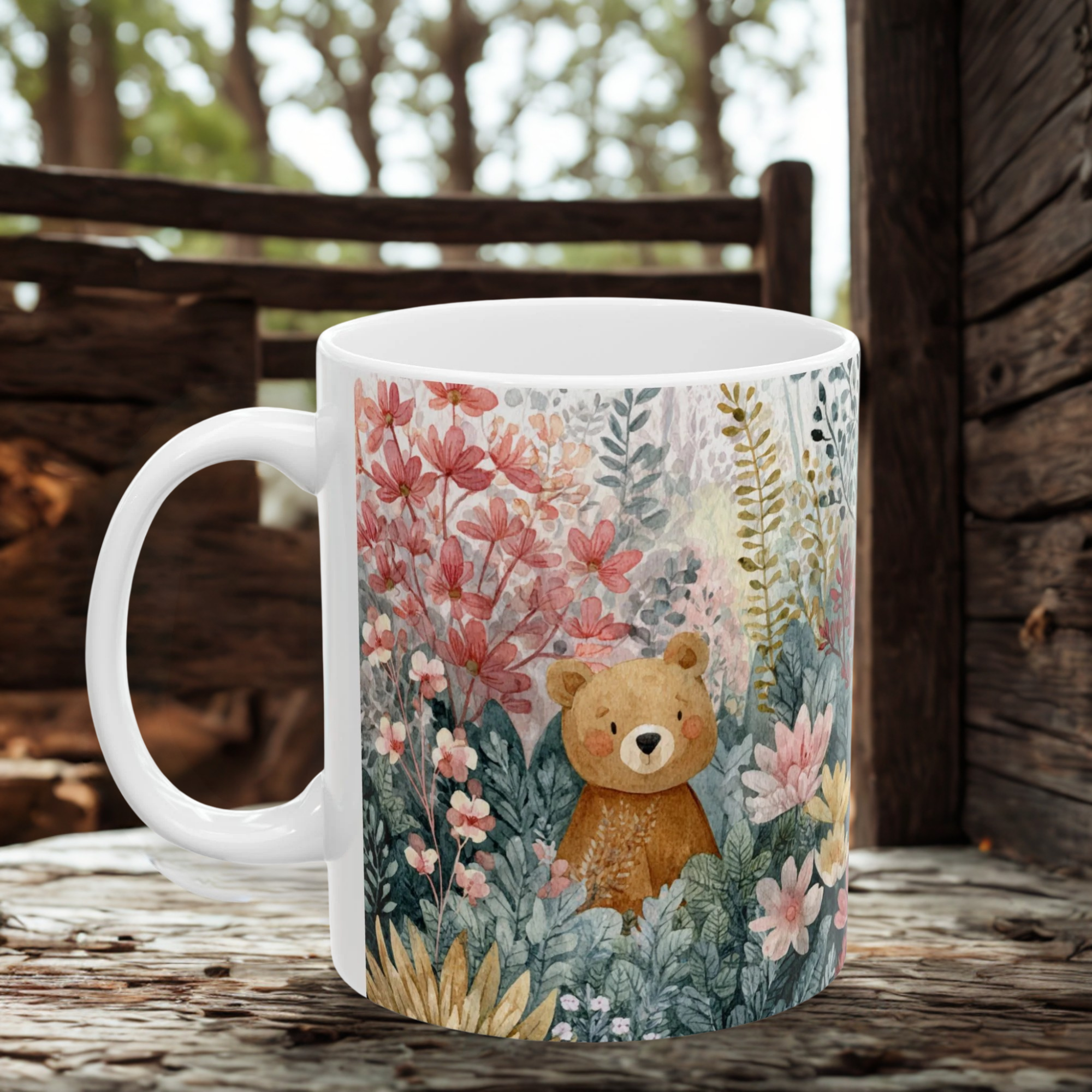 White mug with a bear and floral design on a wooden surface