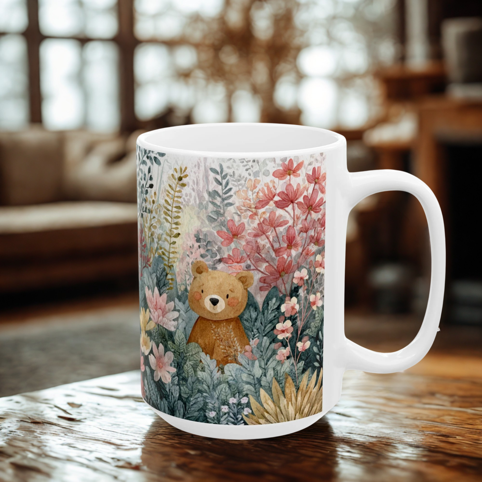 White mug with a teddy bear and floral design on a wooden table.