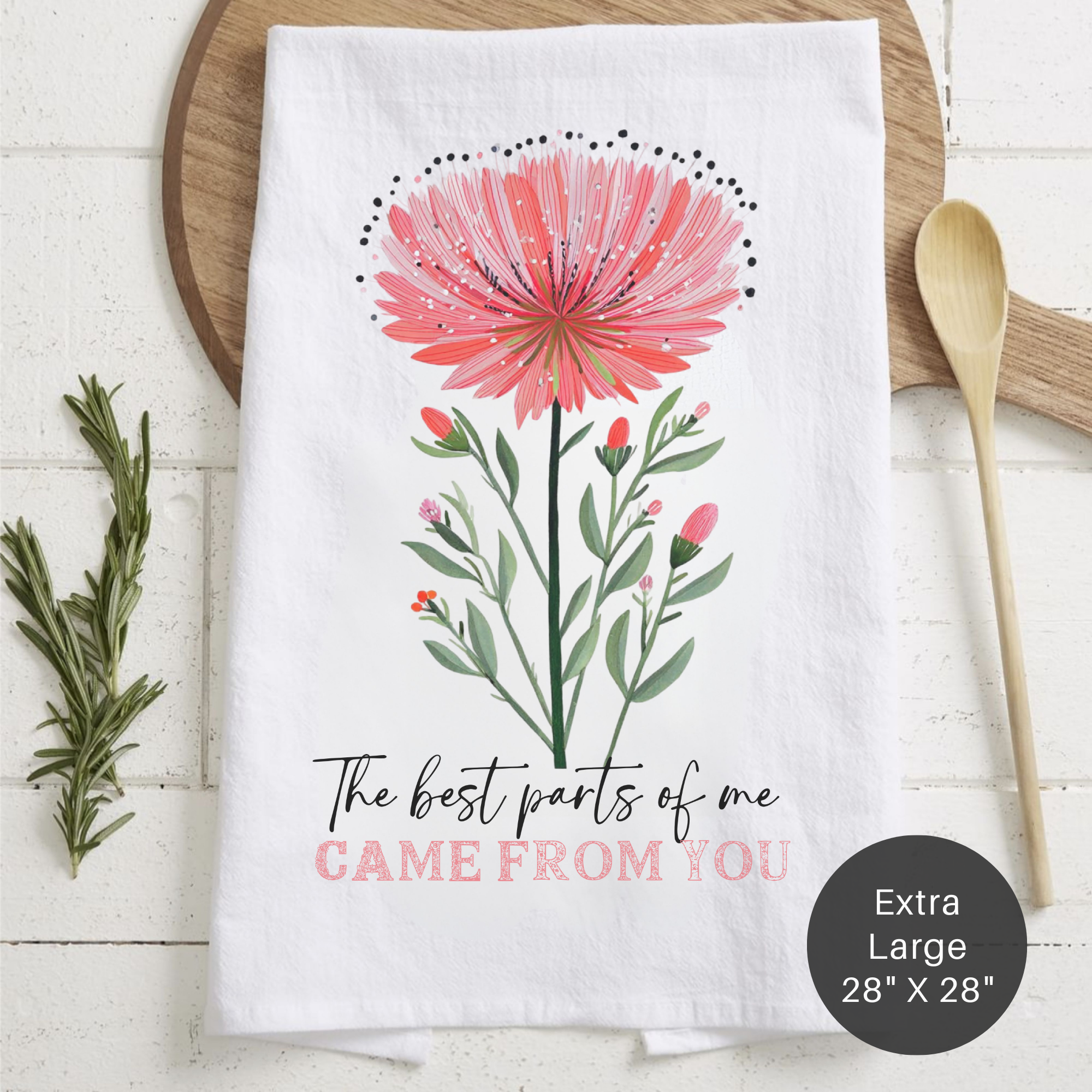 Floral-themed towel with a quote 'The Best Parts Of Me Came From You'  on a wooden surface