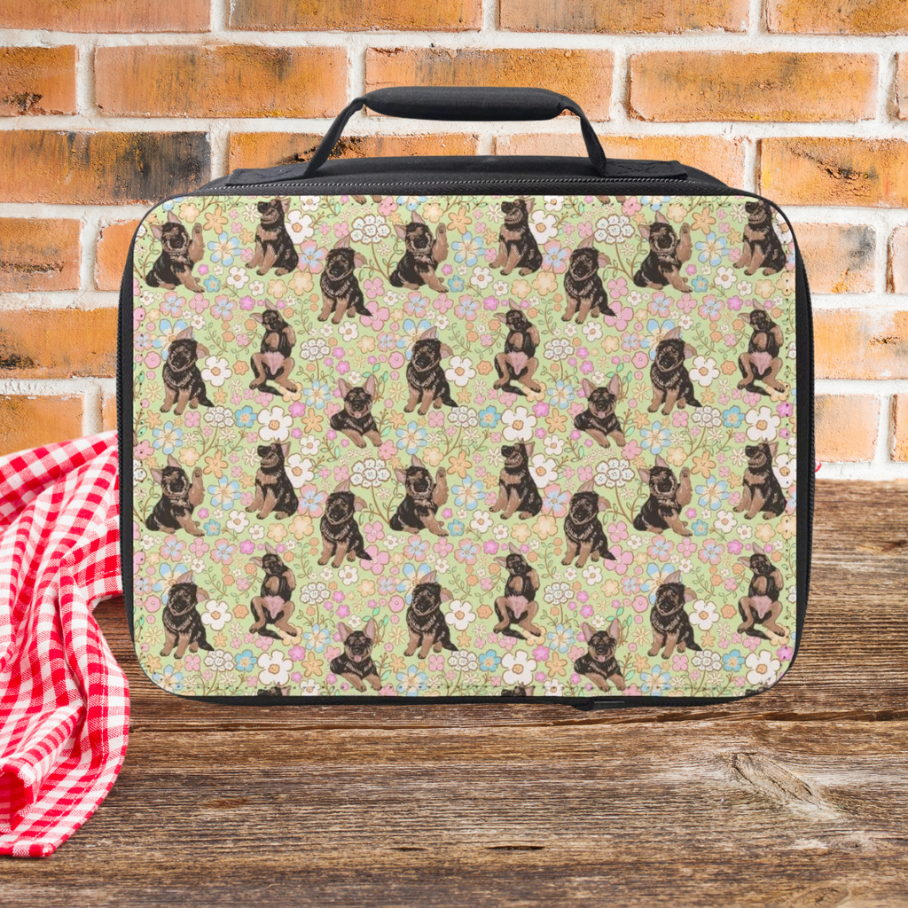 Lunch bag with hand drawn floral dog pattern on a wooden picnic table and brick wall background