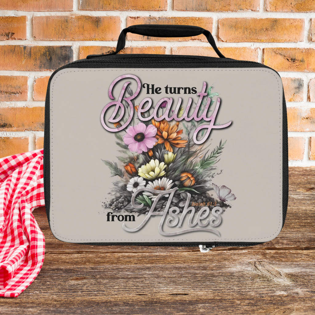Lunch bag with floral design and text against a brick wall background