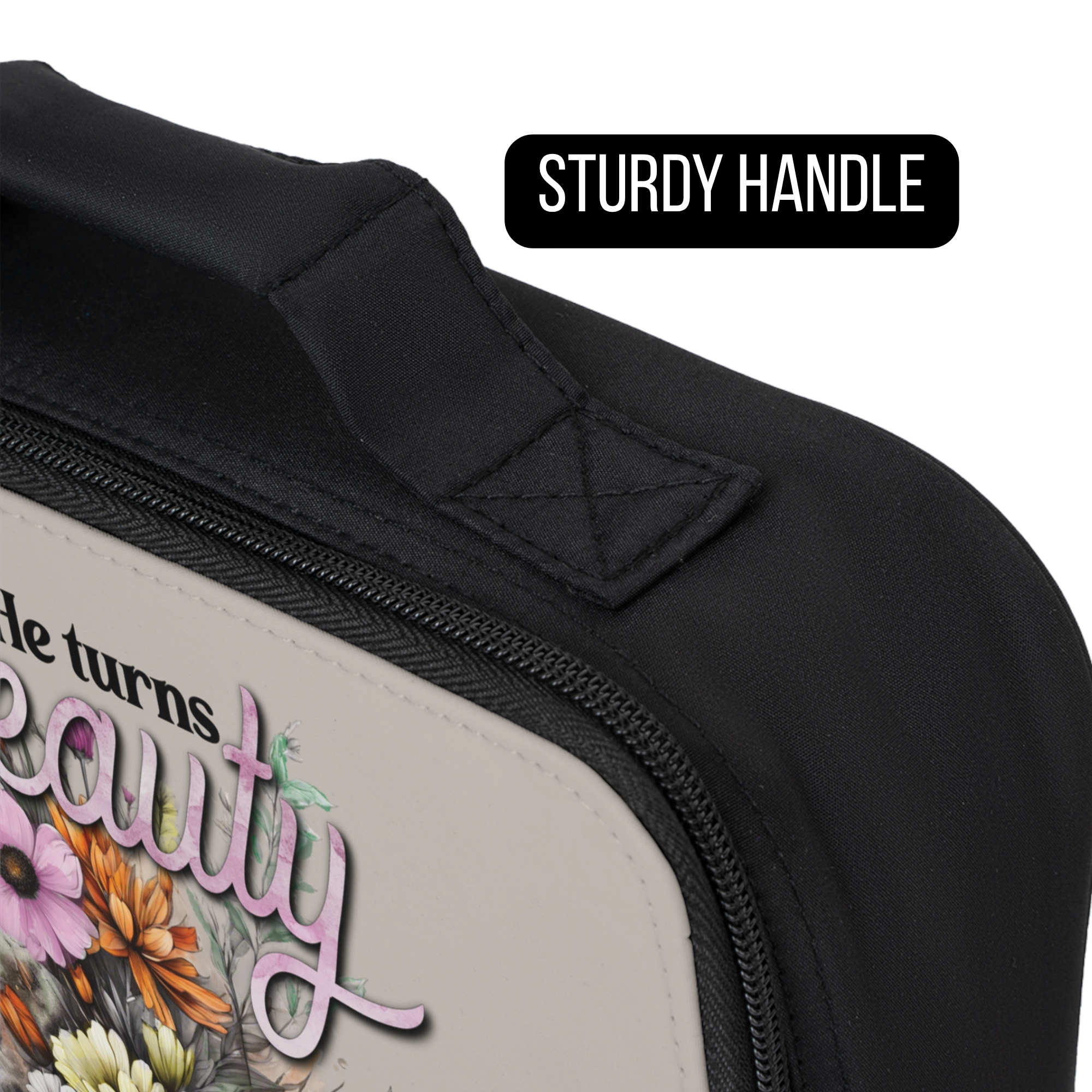 Black lunch bag with floral design and text, focusing on the sturdy handle.
