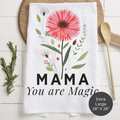 Floral towel with 'MAMA You are Magic' text on a wooden surface