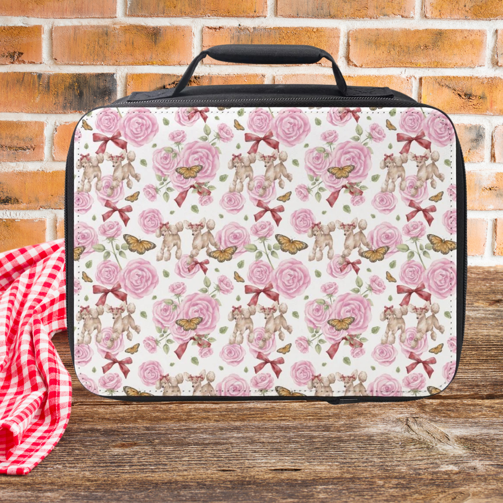Floral and poodle dog patterned lunch bag on a wooden surface with a brick wall background