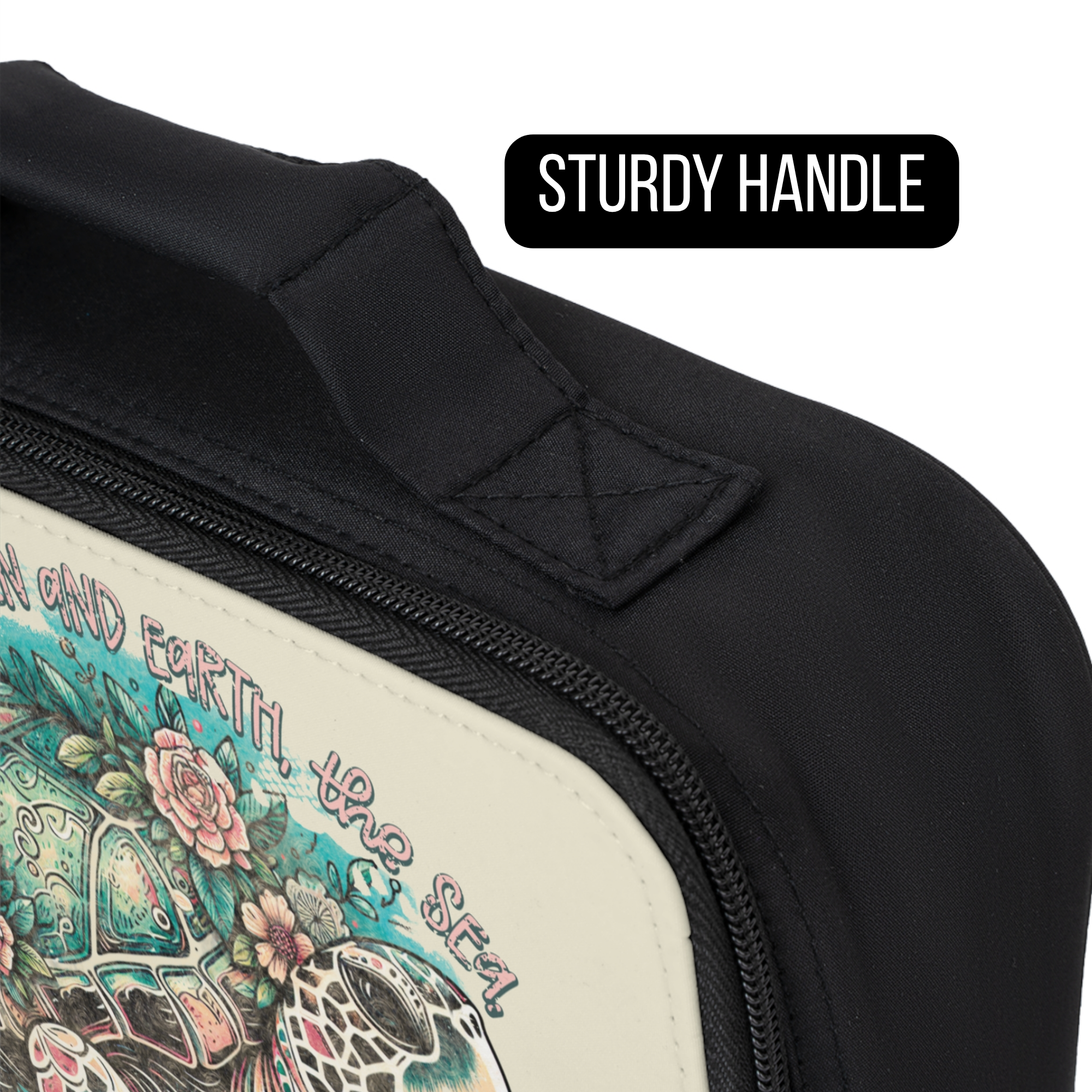 Close-up of a black bag with a turtle design and text, highlighting the sturdy handle.