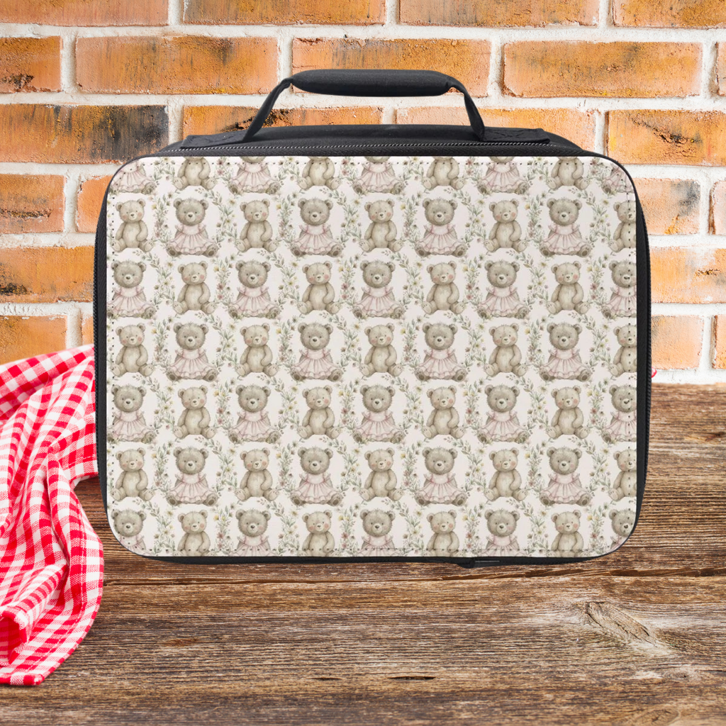 Lunch bag with teddy bear pattern on a wooden picnic table and brick wall background