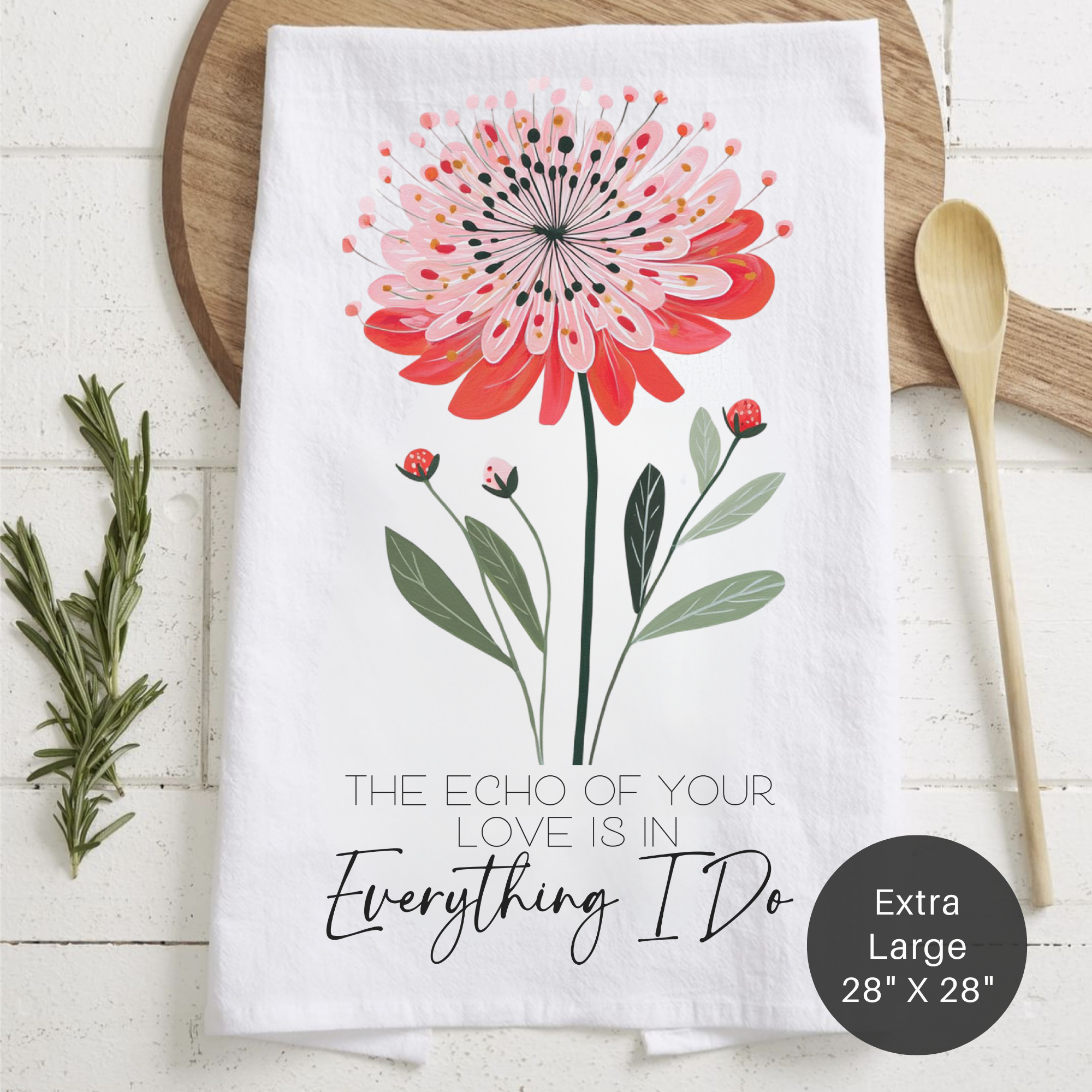 Floral design towel with text 'The Echo Of Your Love Is In Everything I Do' on a wooden surface