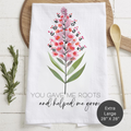 Floral design towel with text 'You Gave Me Roots And Helped Me Grow' on a wooden surface