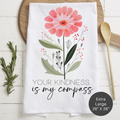 Floral-themed towel with text 'Your Kindness Is My Compass' on a wooden surface