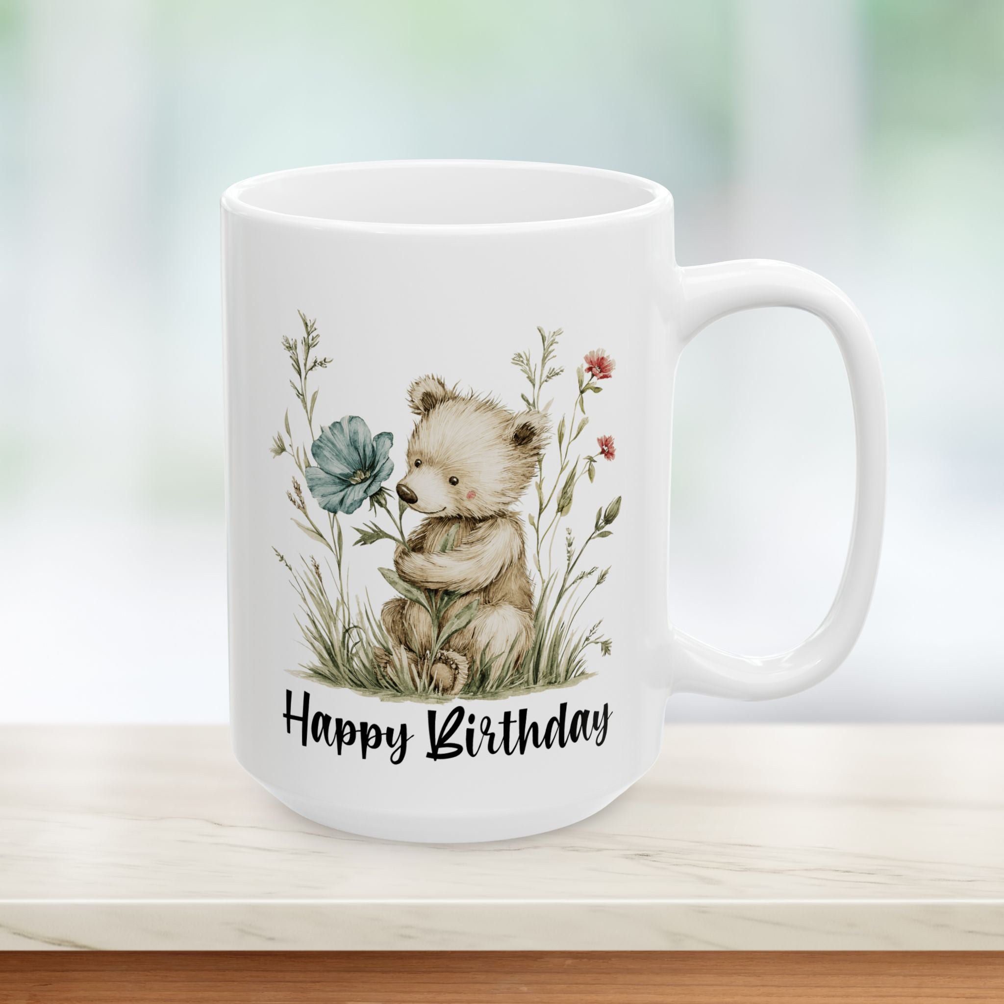 White mug with a bear holding a flower and 'Happy Birthday' text on a blurred background