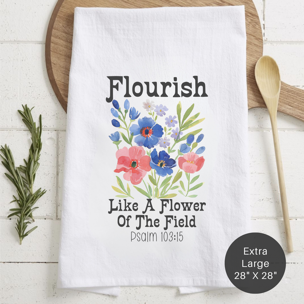 White tea towel with floral design and text 'Flourish Like A Flower of The Field, Psalm 103:15' on a counter
