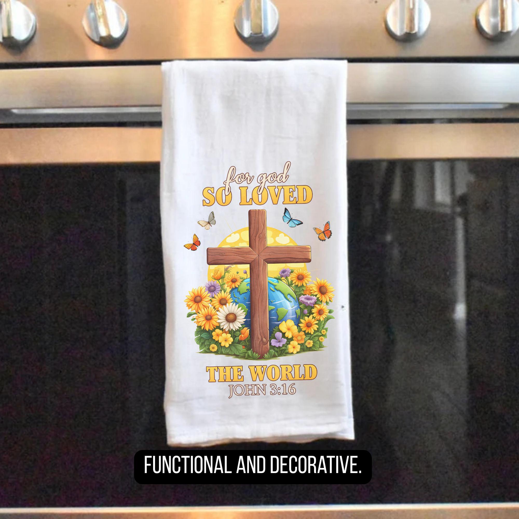 Decorative tea towel with cross and flowers hanging on a stove.