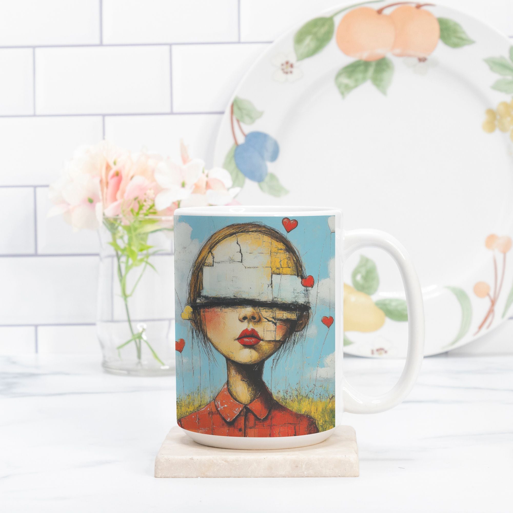 Mug with artistic design of a girl with hearts, placed on a marble coaster with a white tiled wall and flowers in the background.