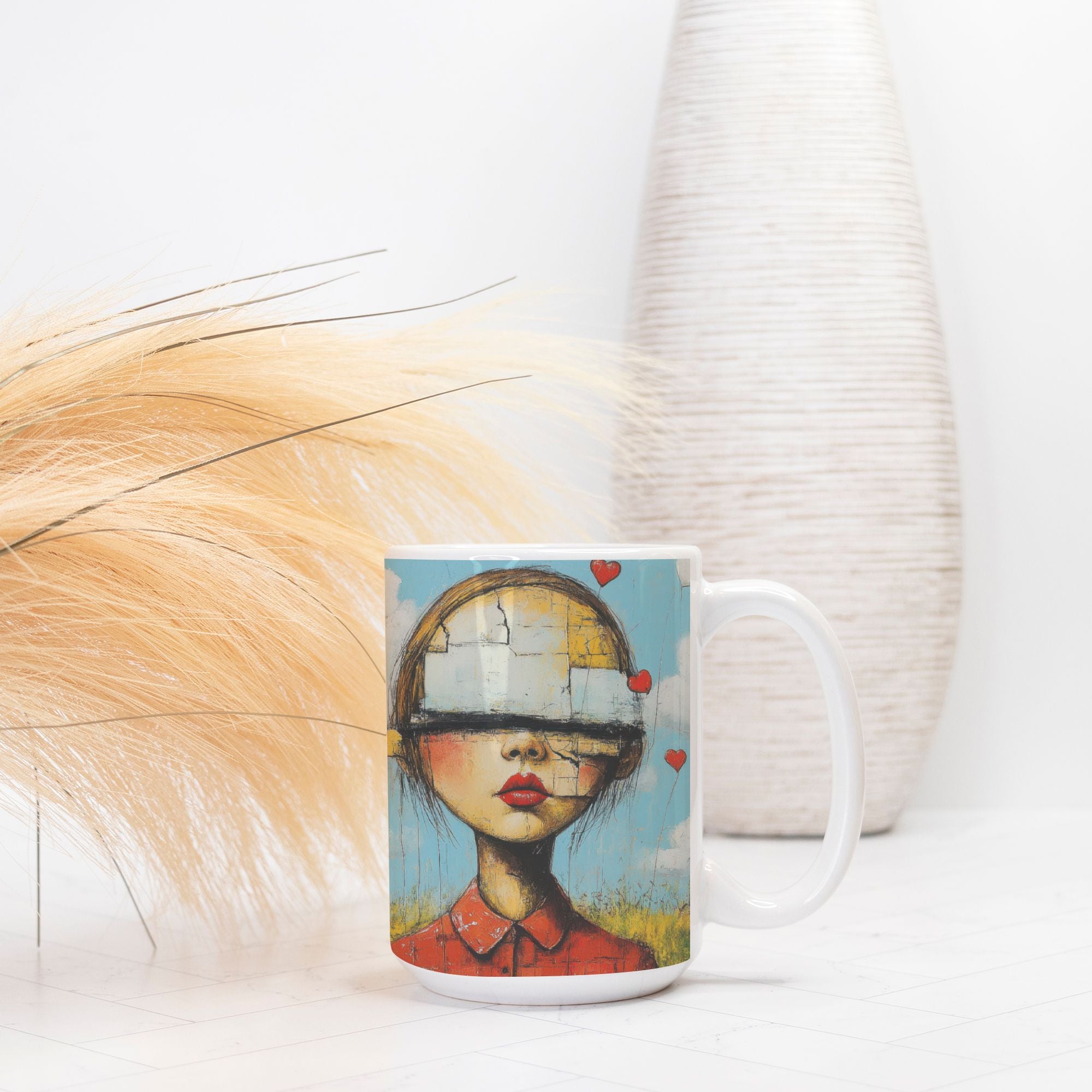 Mug with artistic design of a woman's face on a white surface with a vase in the background