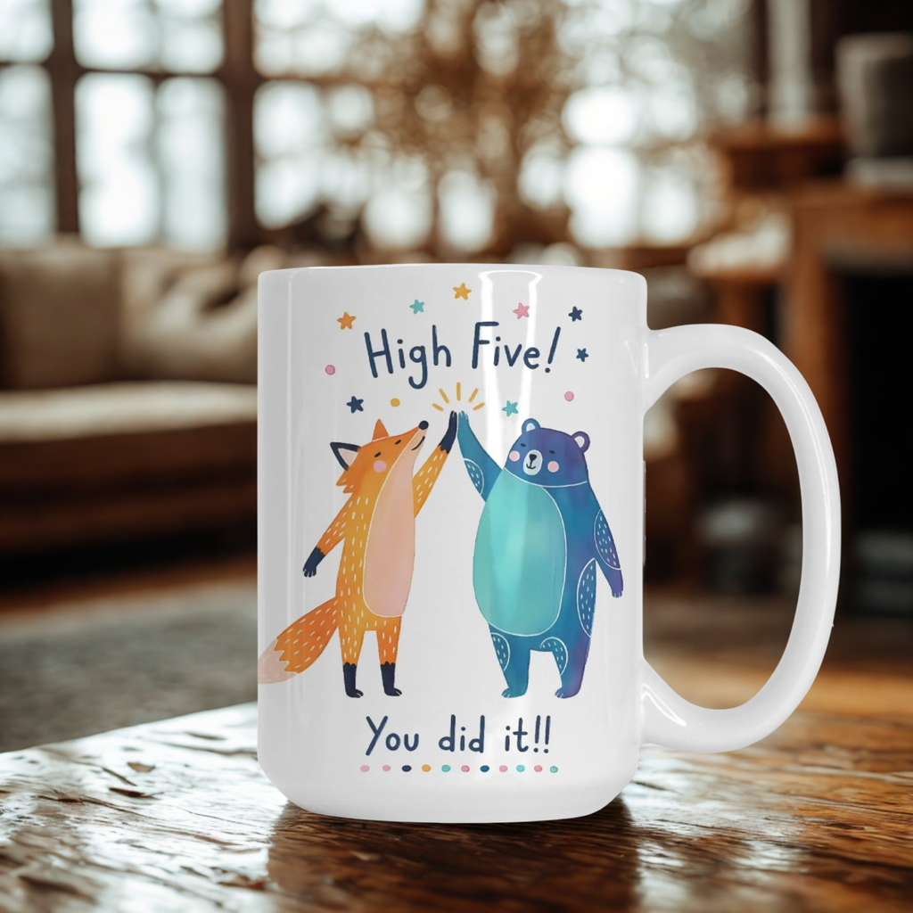 Mug with cartoon fox and bear design and text 'High Five! You did it!!' on a wooden surface.