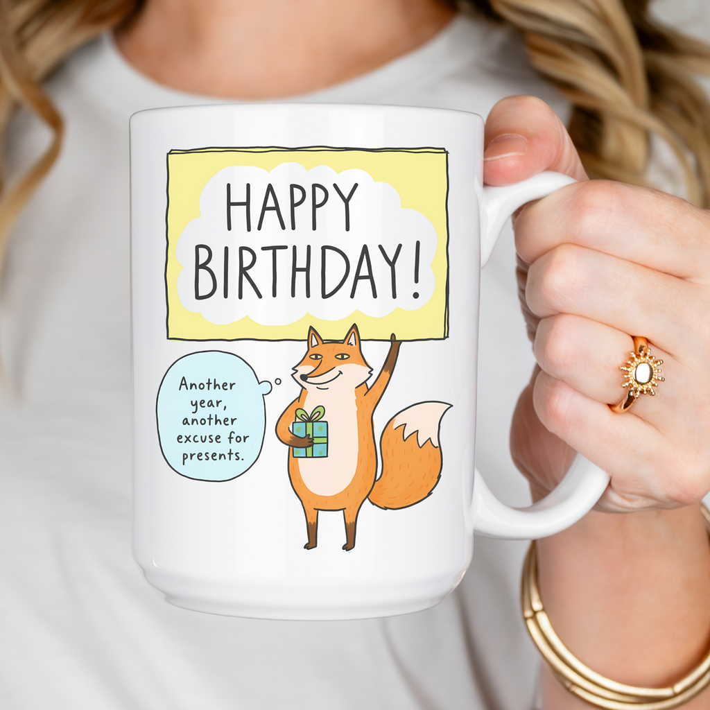 Person holding a mug with a fox illustration and 'Happy Birthday!' text