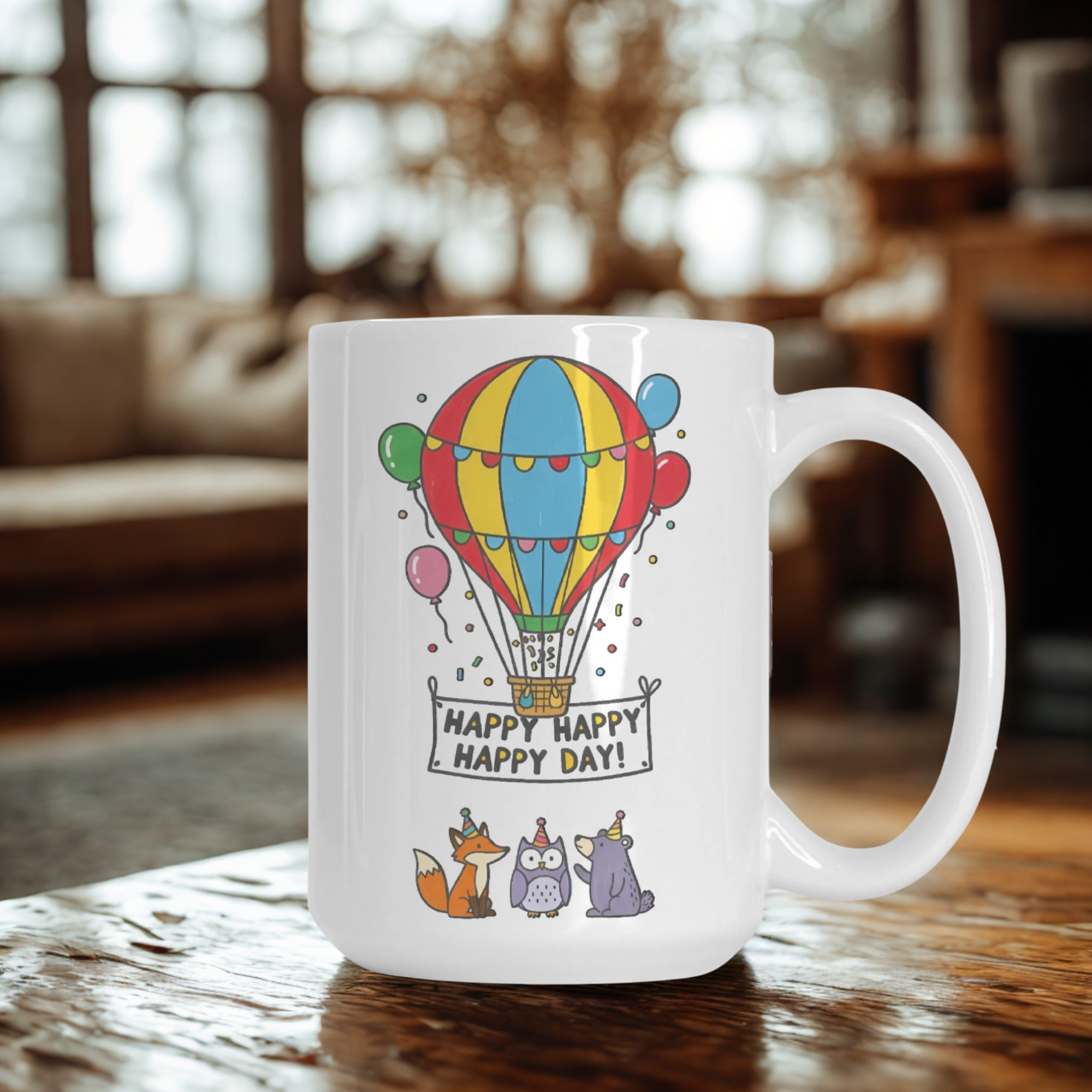 White mug with colorful hot air balloon design and 'Happy Happy Happy Day!' text on a wooden table.