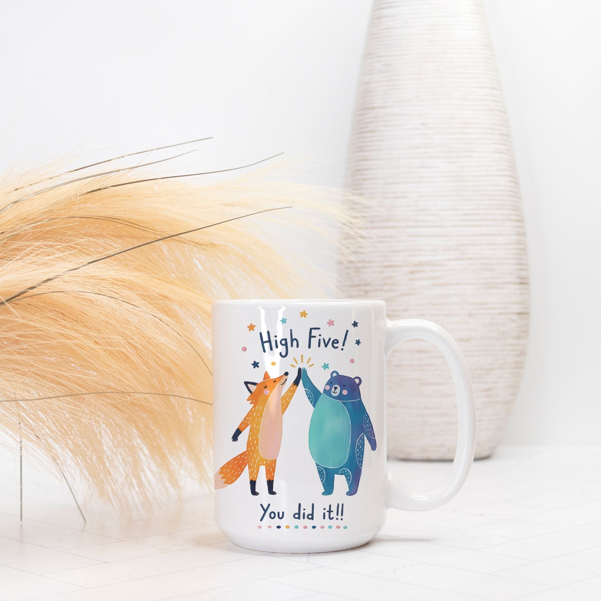 Mug with fox and bear design and text 'High Five! You did it!' on a white background