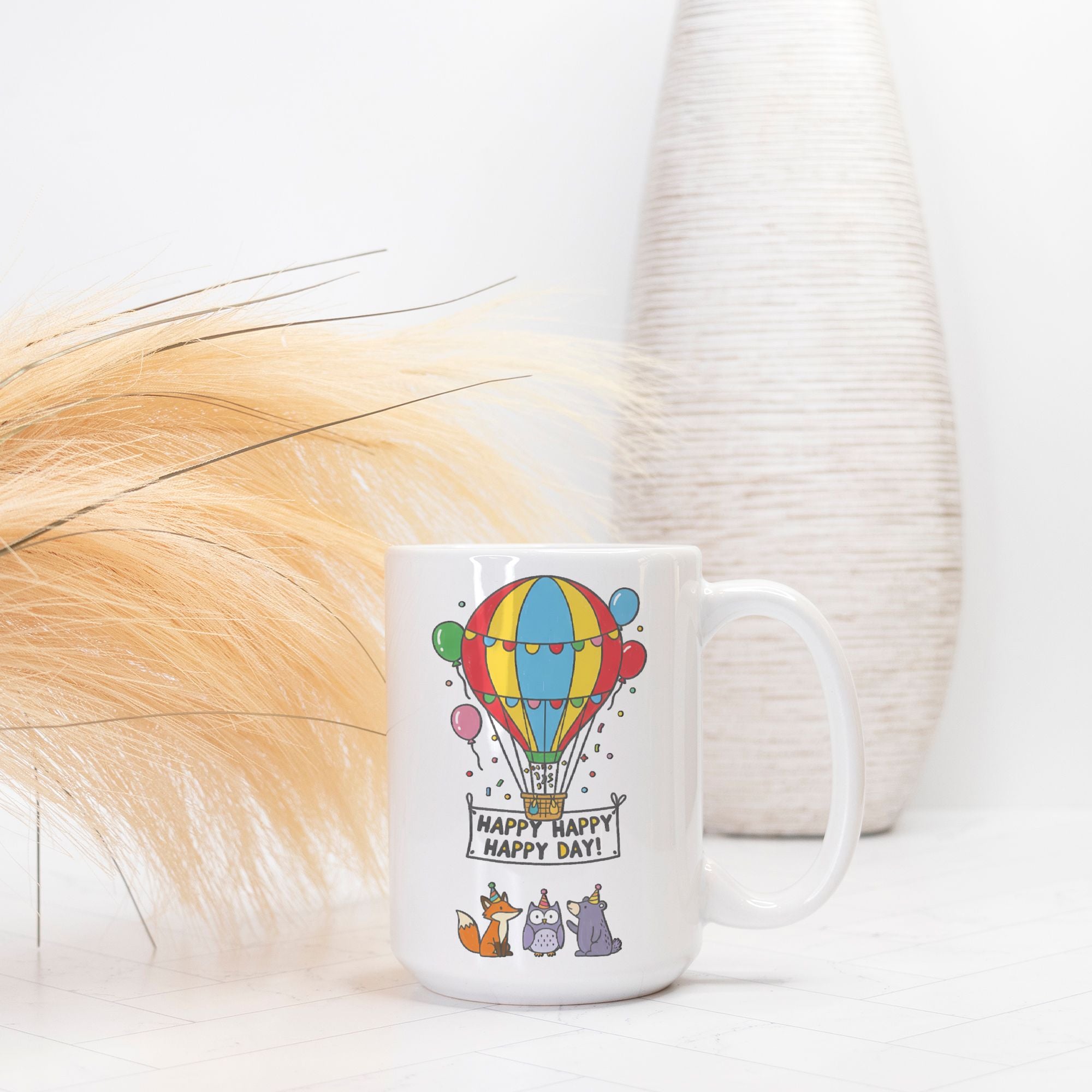 White mug with colorful hot air balloon design and text on a white background
