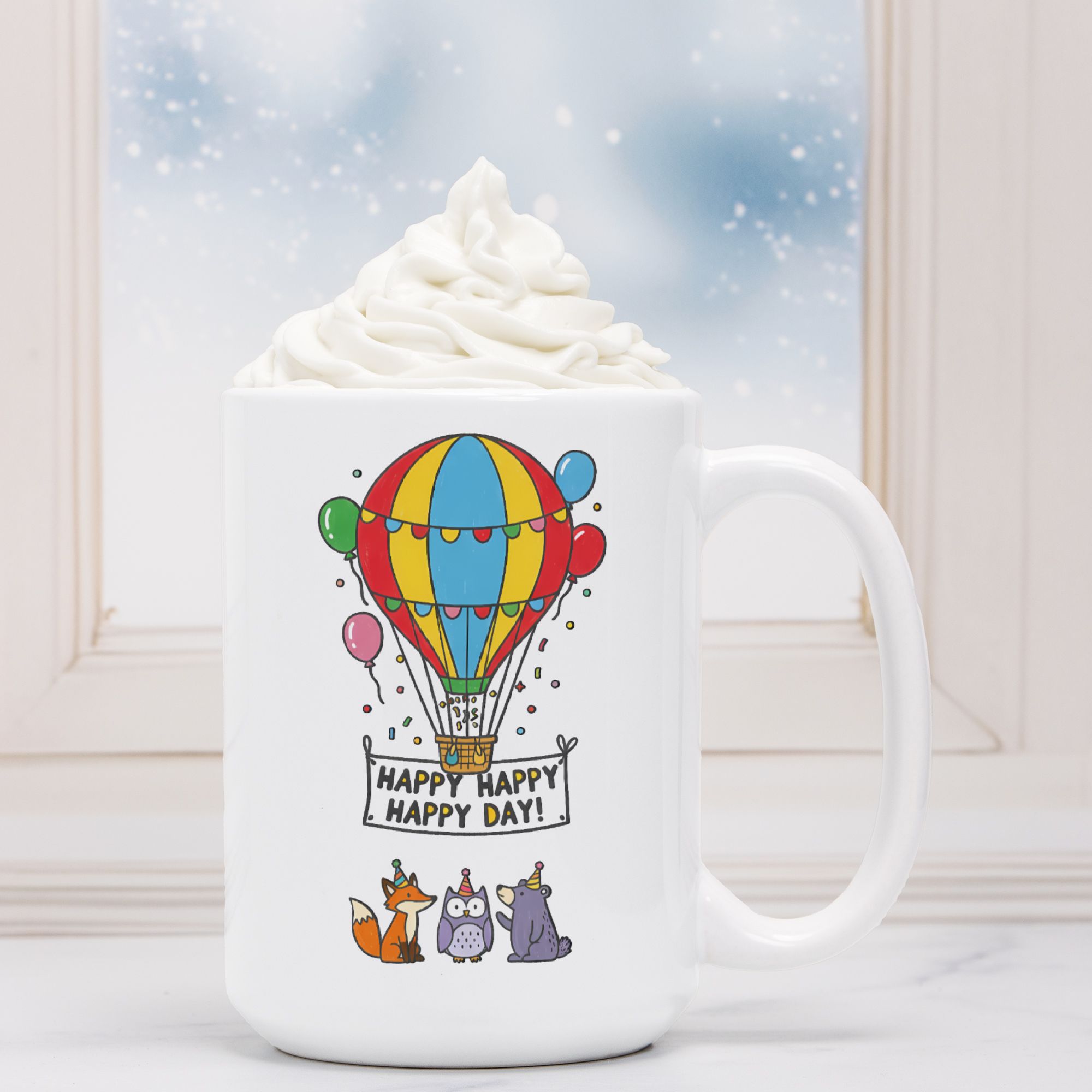 White mug with a colorful hot air balloon design and 'Happy Happy Happy Day' text, filled with hot chocolate.