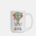 White mug with colorful hot air balloon design and text on a white background
