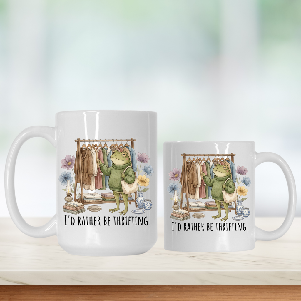 11oz & 15oz  mugs with a frog character and text 'I'd Rather Be Thrifting' on a white background.