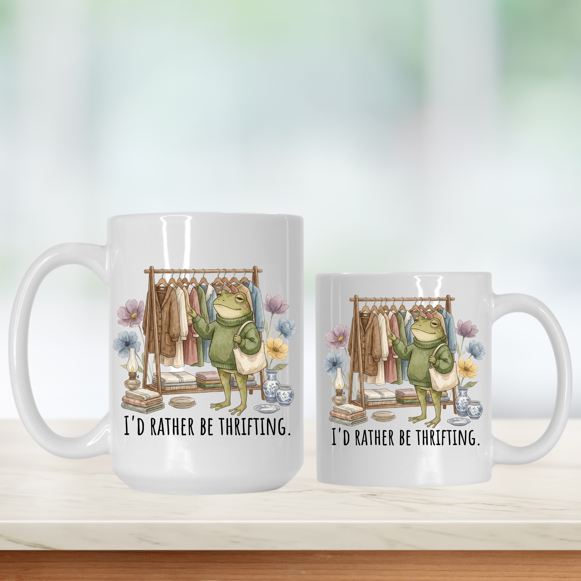 11oz & 15oz  mugs with a frog character and text 'I'd Rather Be Thrifting' on a white background.