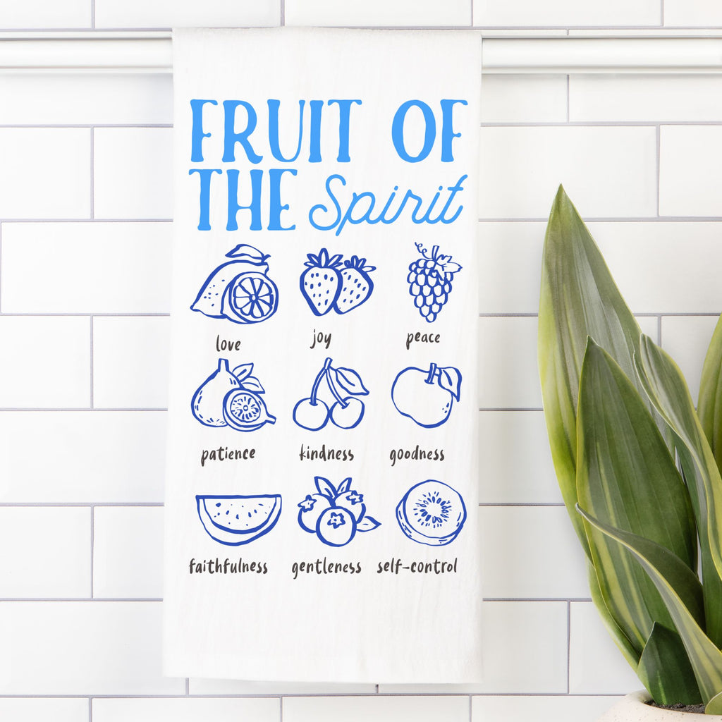Tea towel with Illustrations of the 'Fruit of the Spirit' with corresponding fruits on a white tiled wall.