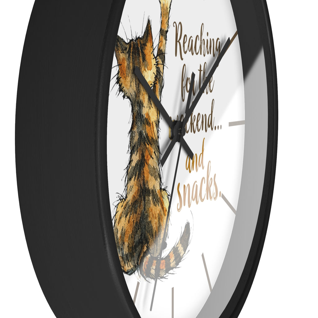 Side view of a round black wall clock with a cat illustration and text on a white background