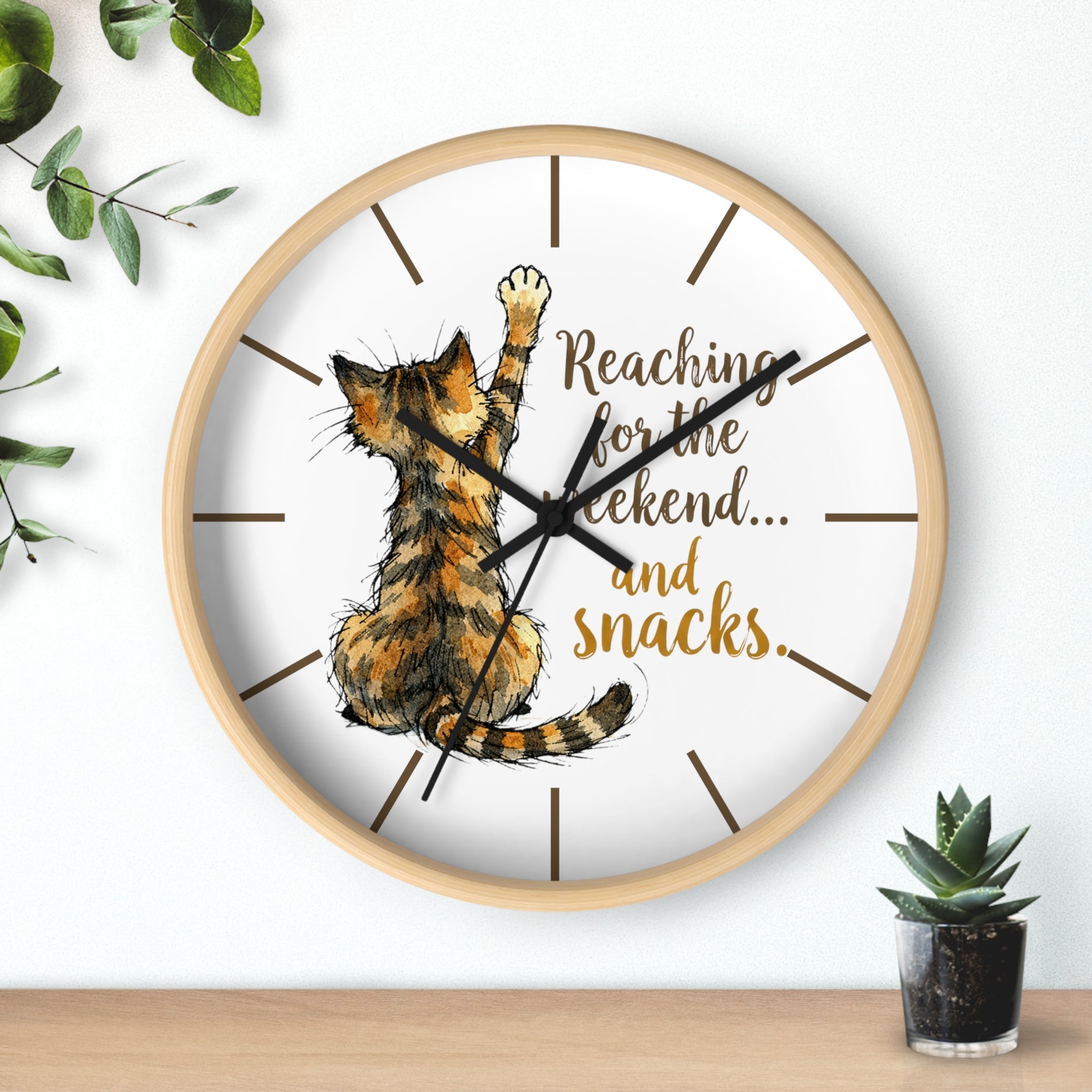 Round wood wall clock with a cat illustration and text on a white background