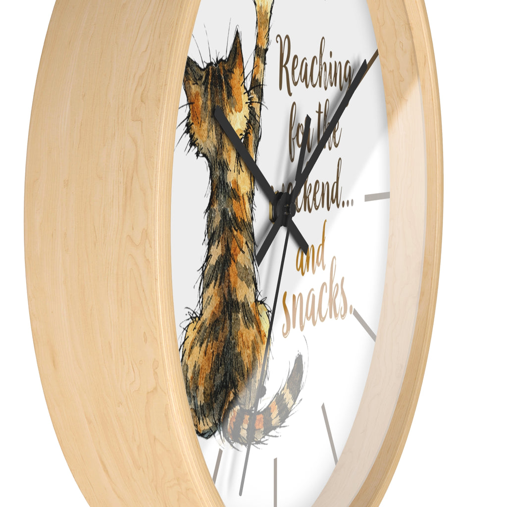 Side view of a round wood wall clock with a cat illustration and text on a white background