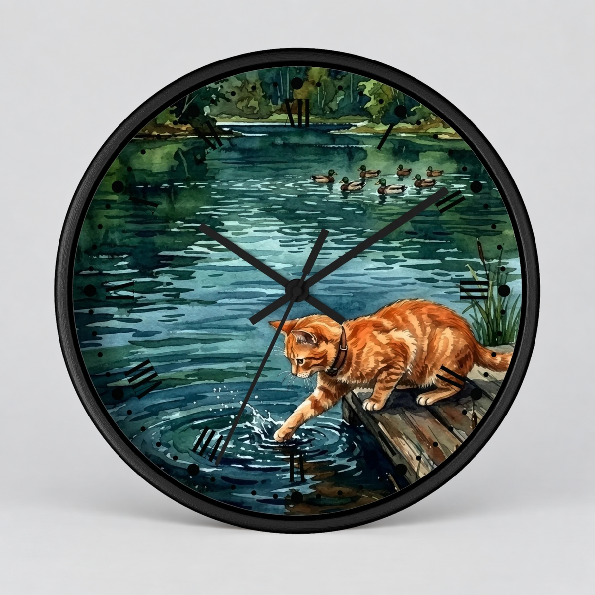 Round wall clock with a black frame and a printed illustration of an orange tabby cat reaching into a pond, with ducks and greenery in the background.