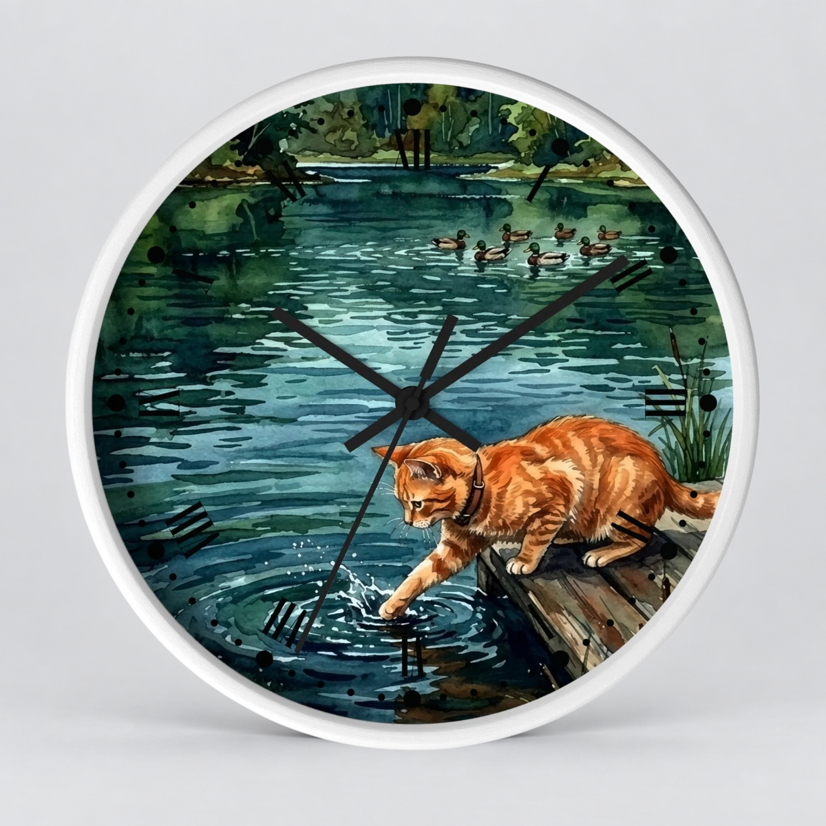 Round wall clock with a white frame and a printed illustration of an orange tabby cat standing on a log by a pond, reaching into the water, with ducks in the background. Black clock hands and black Roman numerals are visible.
