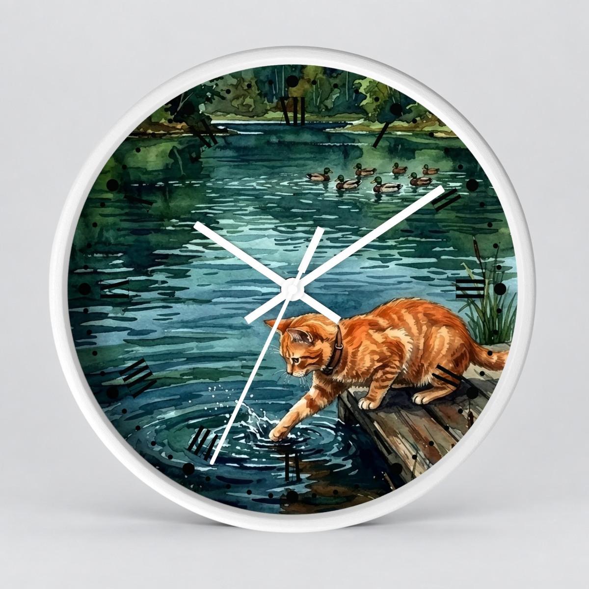 Round wall clock with a white frame and a printed illustration of an orange tabby cat standing on a dock over a pond, with ducks in the water and greenery around the edge. White clock hands are visible against a light gray background.
