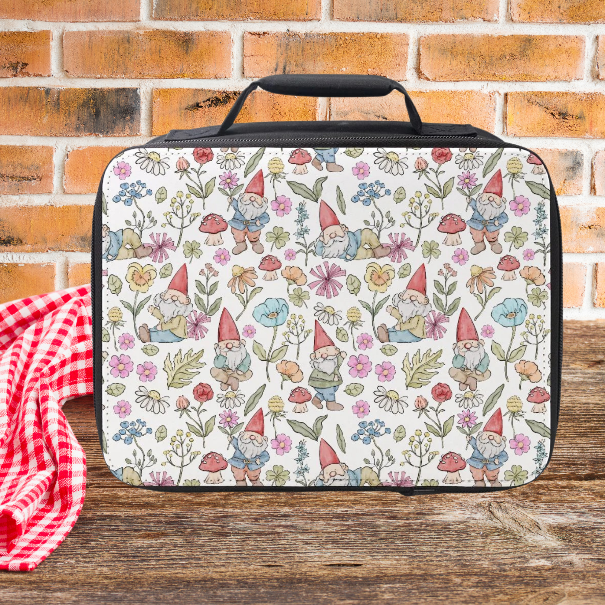 Lunch bag with gnome and floral pattern on a wooden picnic table with a brick wall background