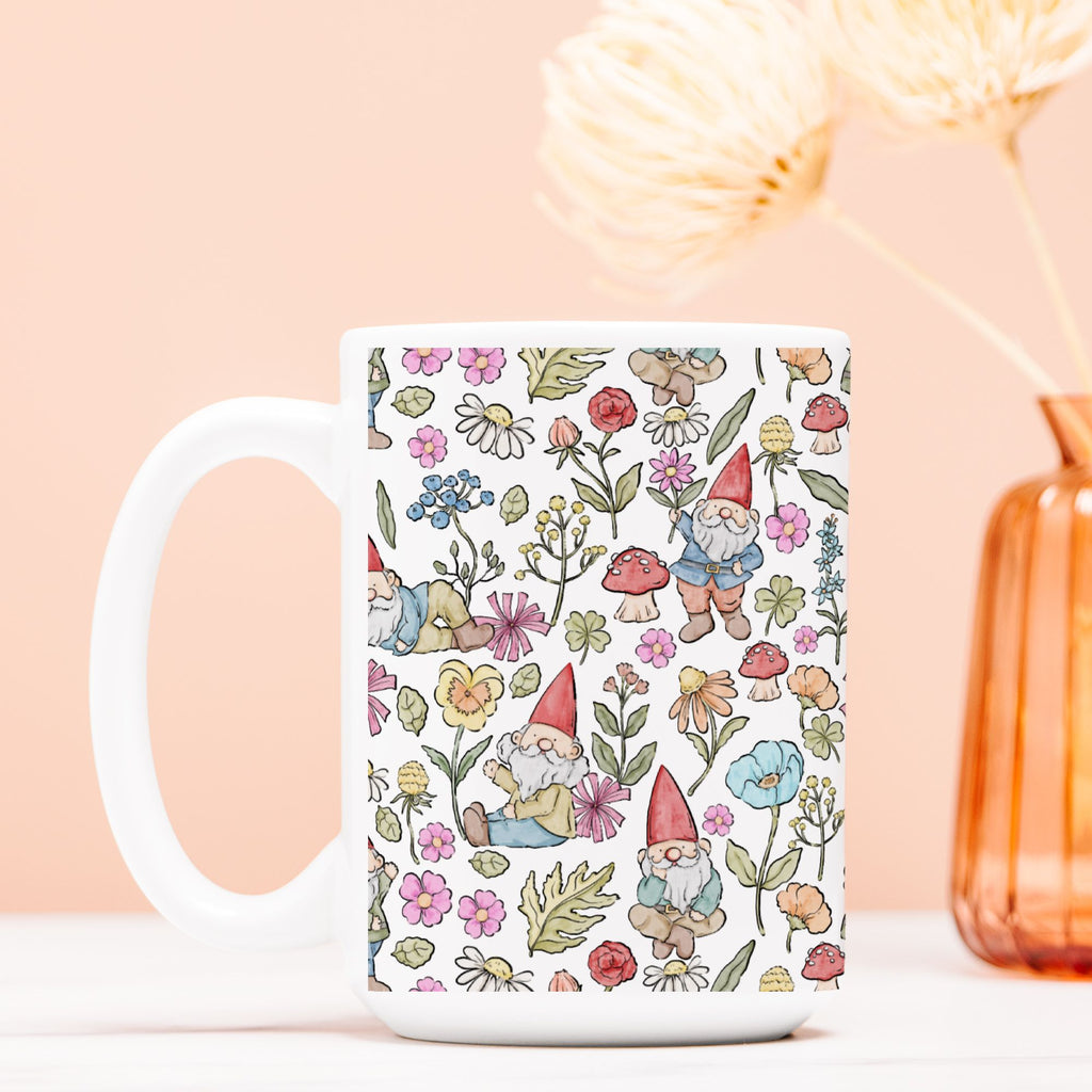 White mug with gnome and floral pattern on a light pink background